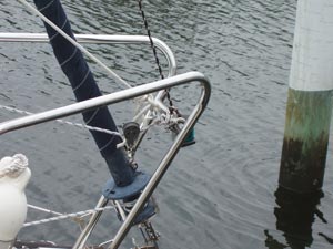 A line from the eye strap on the tip of the MacGregor pole leads to a large snap shackle that snaps around the bow rail.