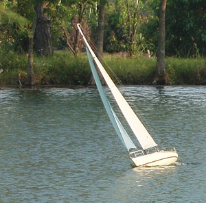Here the boat is trimmed in hard and beating upwind from the fishing bobber mark