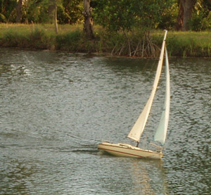 The bow wave is riding up the hull and the  stern is almost completely out of the water