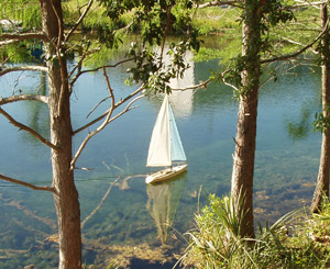 the boat sneaks through some underwater obstacles looking for the strong curtain of wind that sometimes hugs the shore.