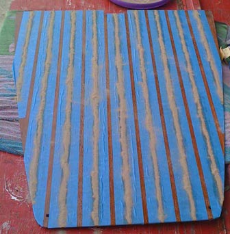 I put a thick coat of varnish on the holly strips, then took some sand and piled up a row of sand over each varnish strip.