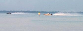 Fishermen throw up roostertails as they head out for the Redfish Tournament