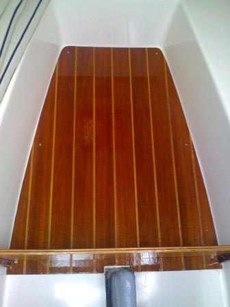 Finished teak-and-sandy sole installed in the cabin of our Sun Cat.