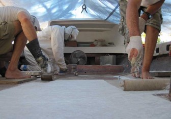 Rolling Resin Into Fiberglass